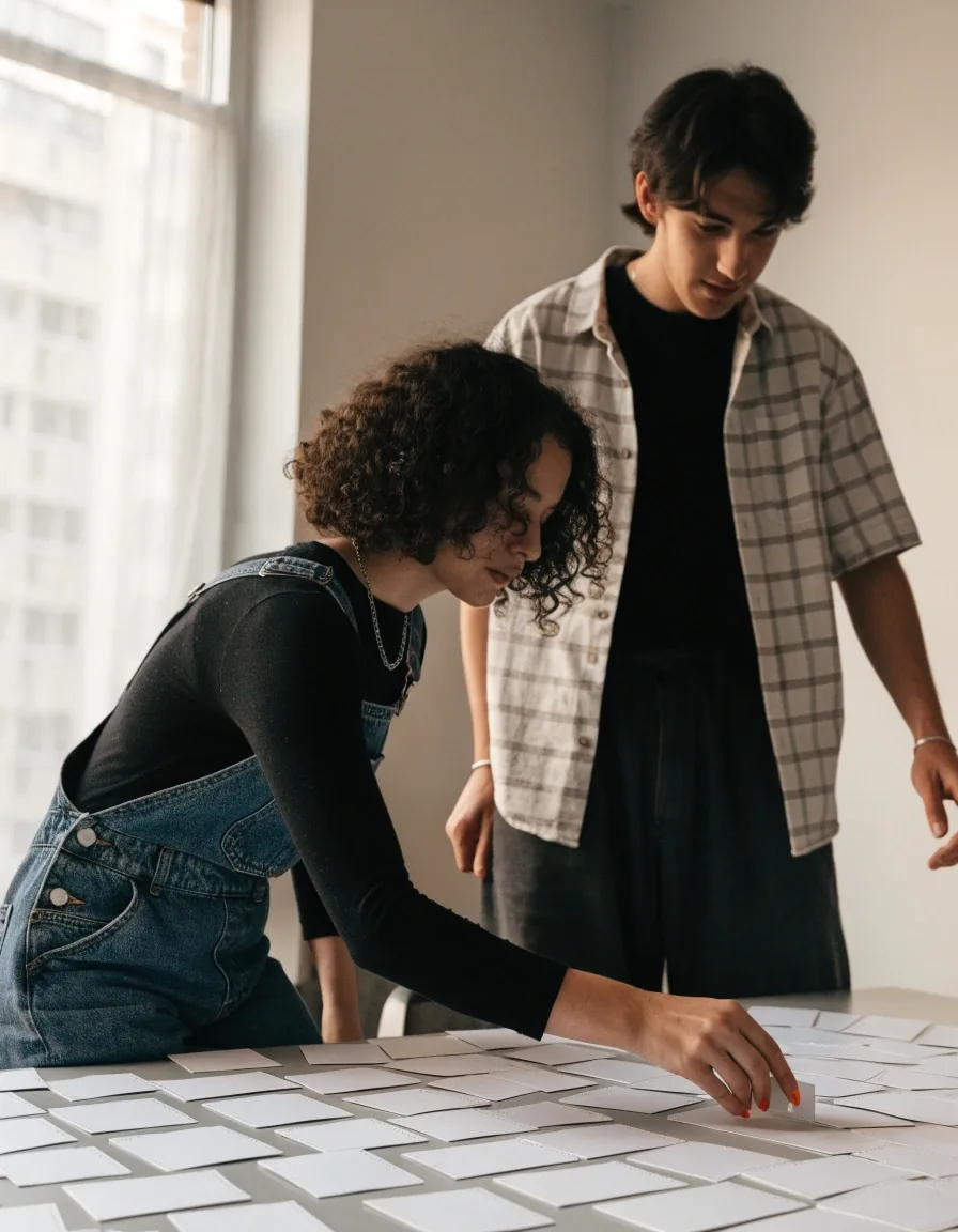 A product designer working on interface microcopy pinned to a studio wall